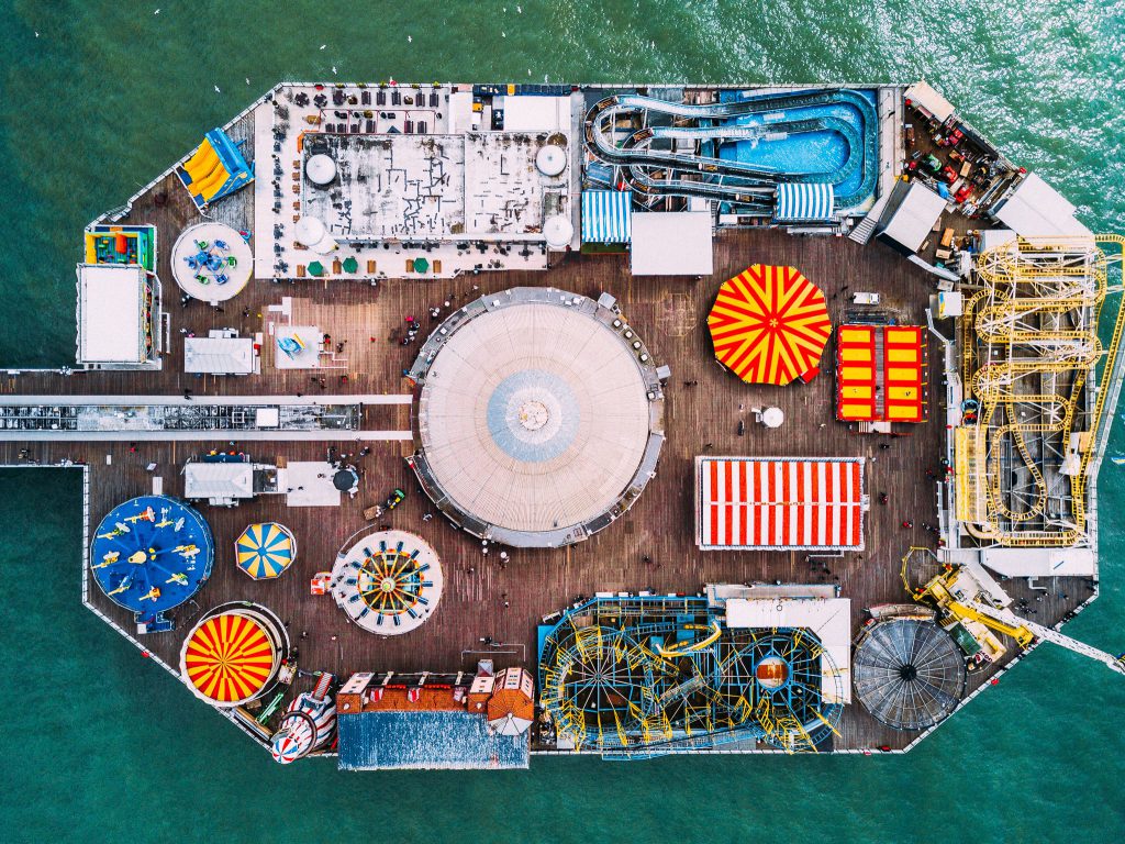 Aerial view of a pier with an assortment of colourful amusement rides