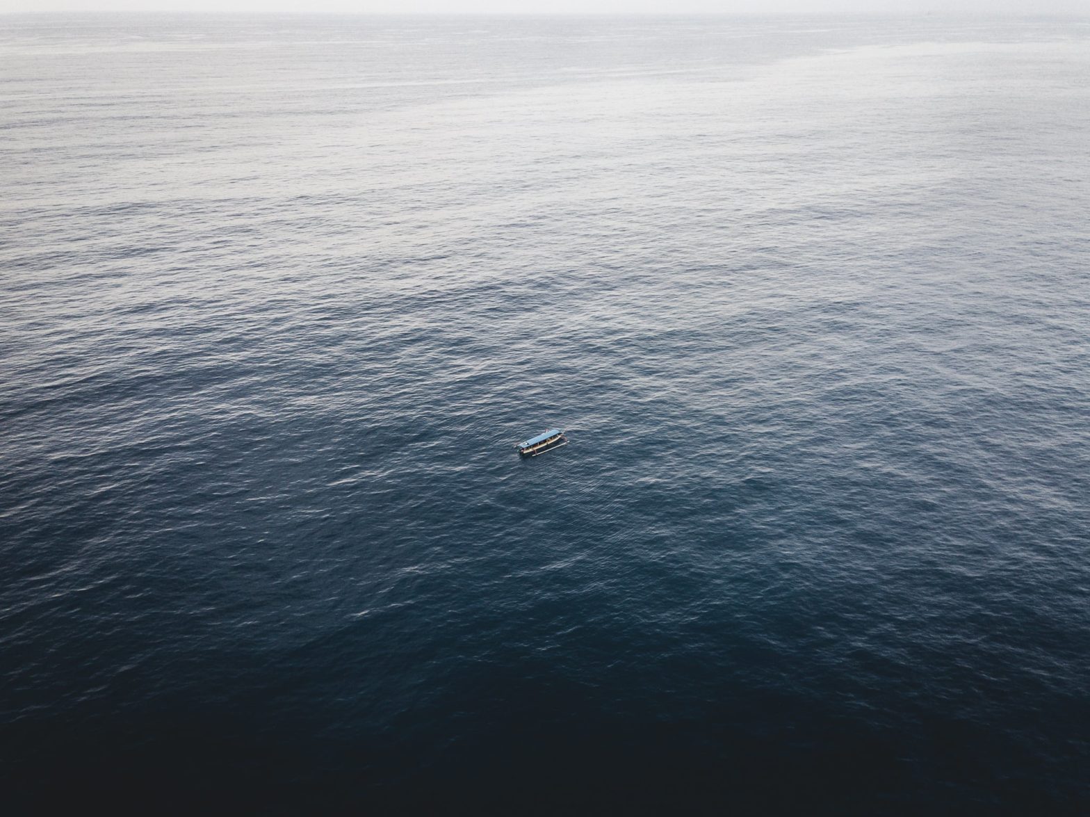 Aerial view of a small boat in the sea