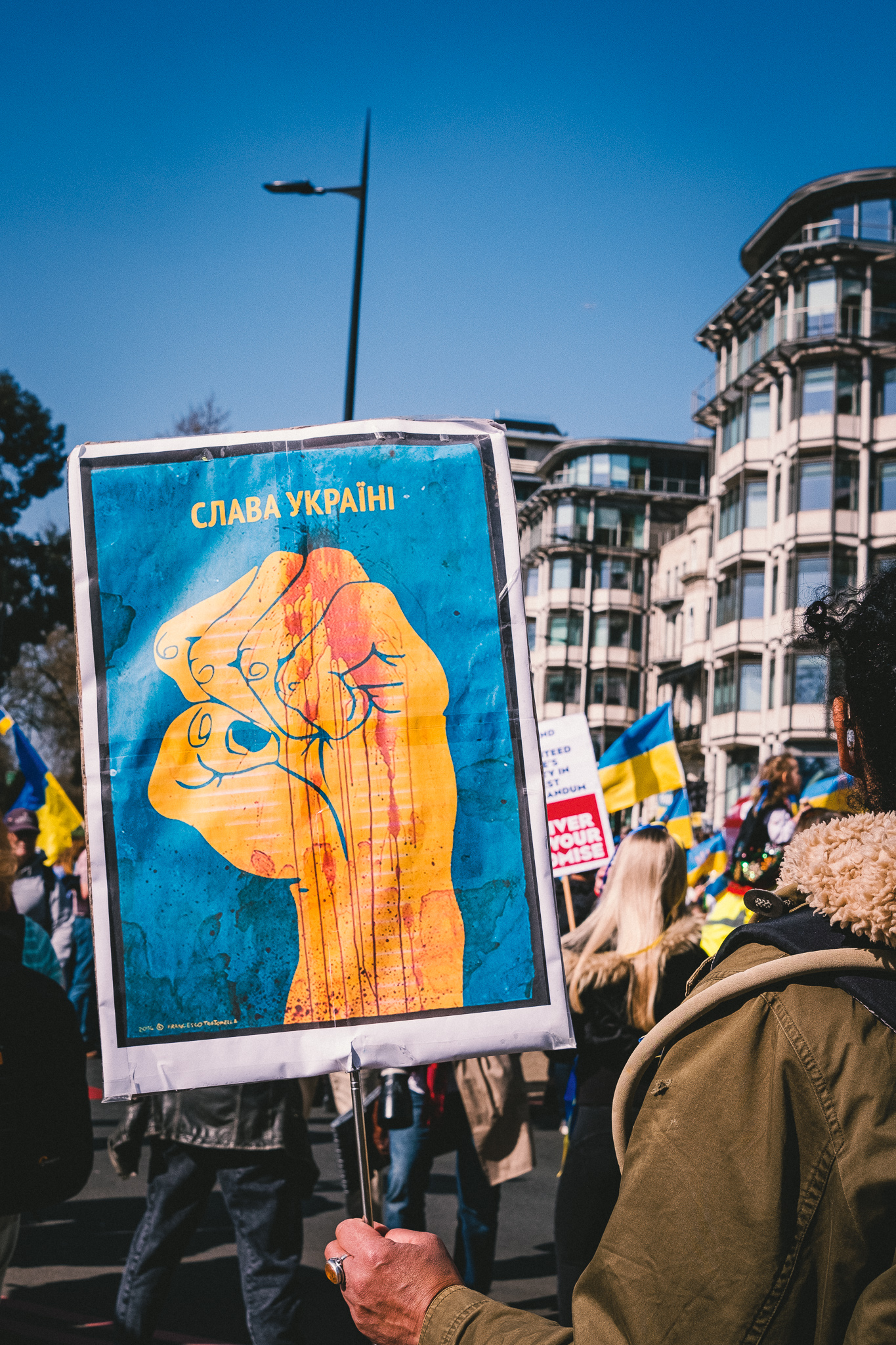 A banner showing a clutching fist in the colours of Ukrainian flag at the solidarity march in London
