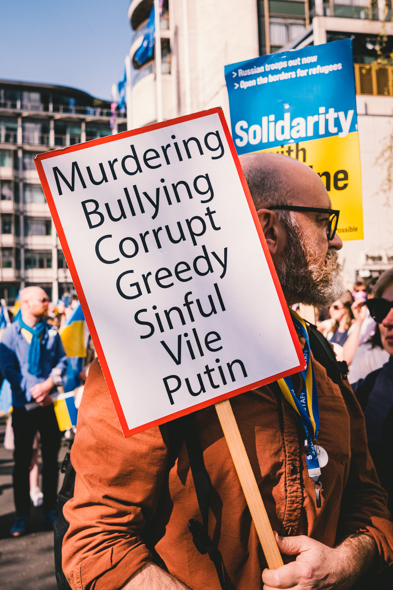 A banner that reads: “Murdering Bullying Corrupt Greedy Sinful Vile Putin” at the solidarity march in London